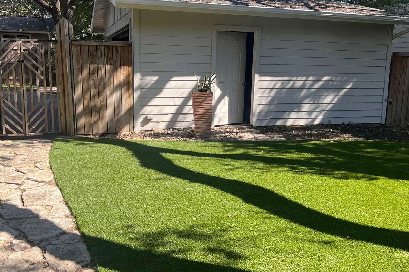 After: a patchy side lawn beside a garage