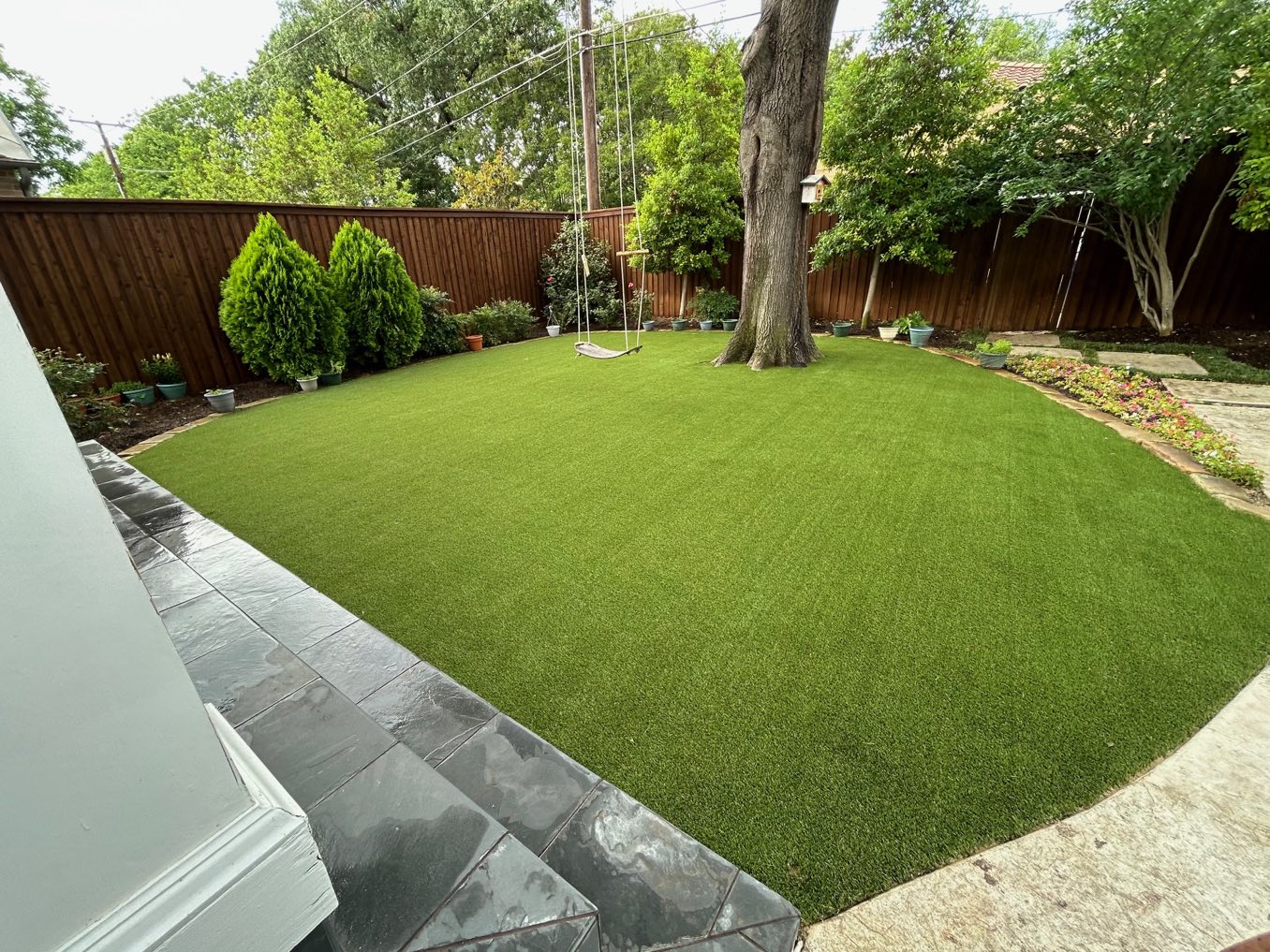 After: a worn circular lawn between a patio and garden beds